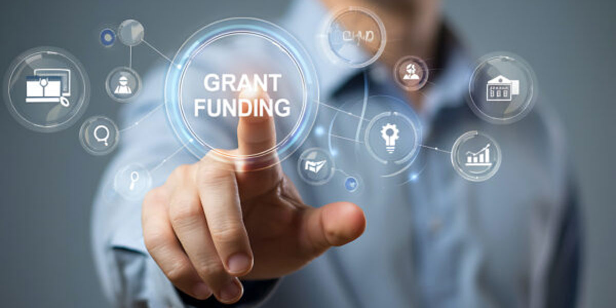 Stock photo of a person tapping on a button for Grant Funding