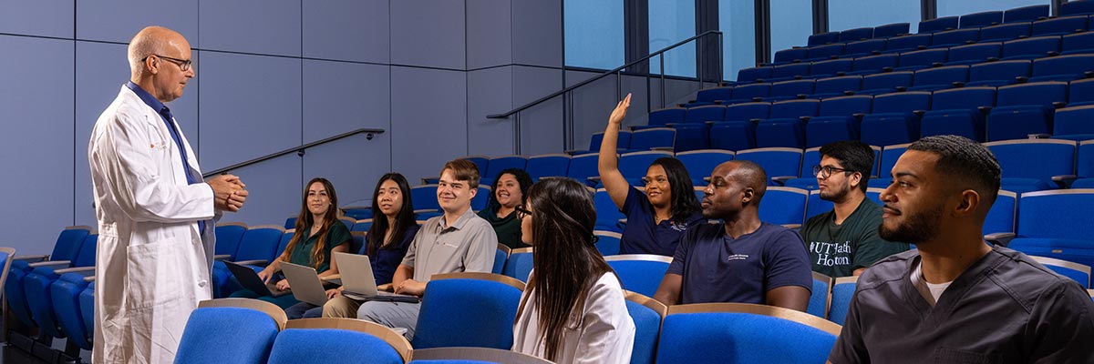 instructor with students in an auditorium