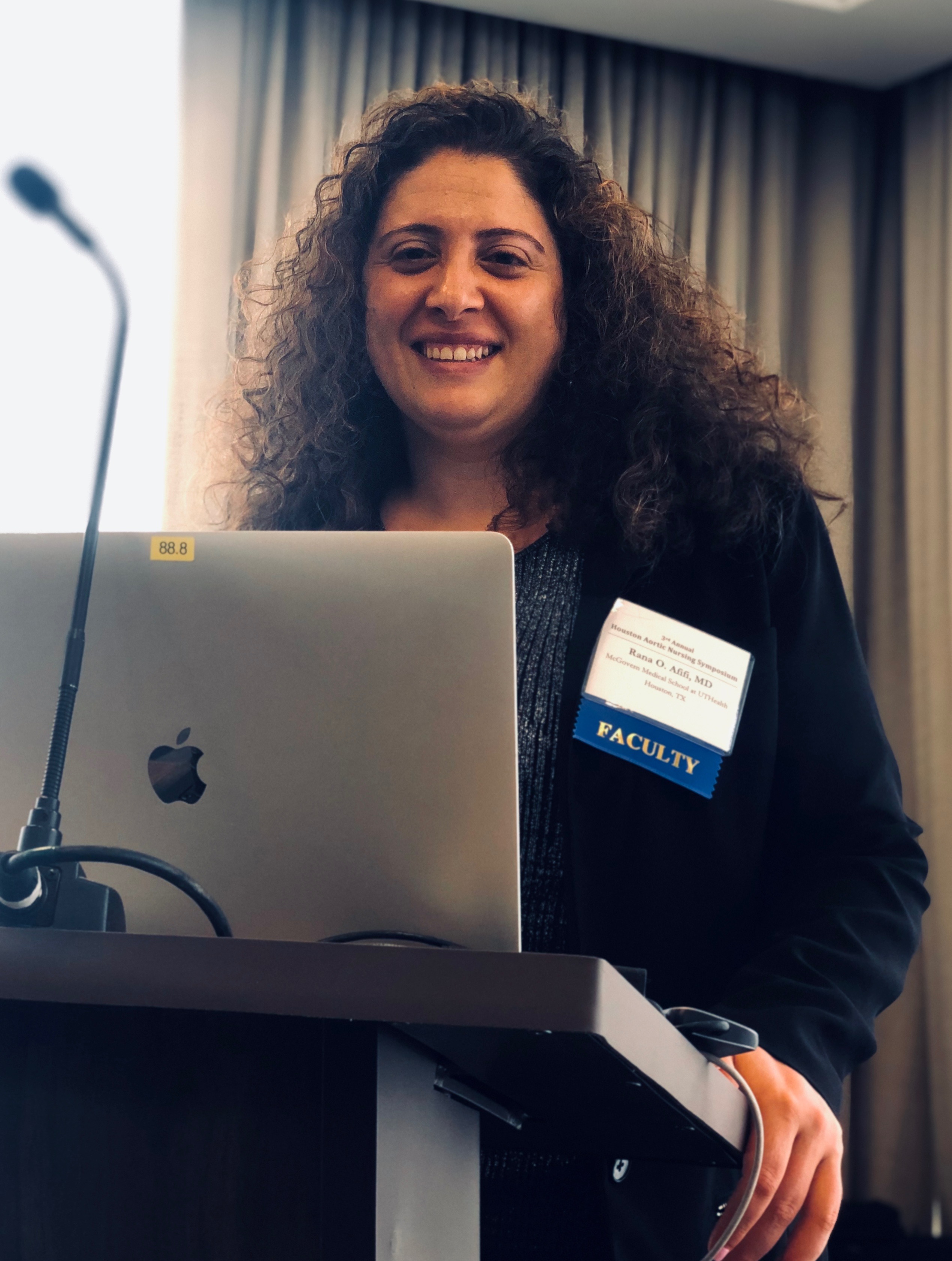 Dr. Rana afifi smiling at podium