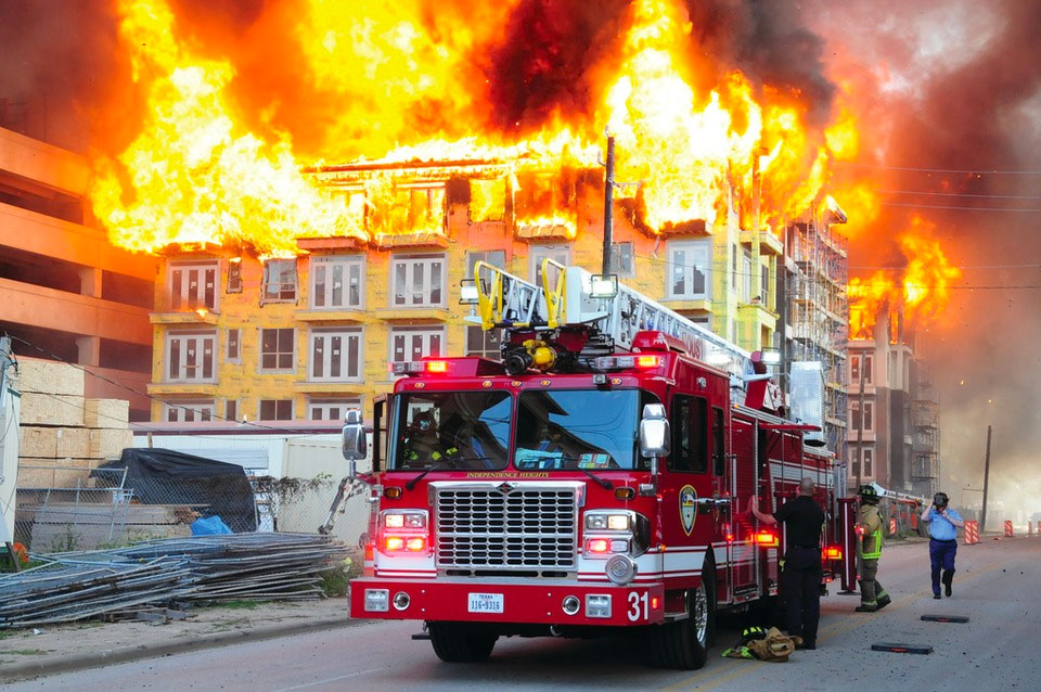 Fire truck in front of blazing building