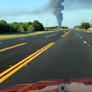 Vehicle driving towards a plume of smoke