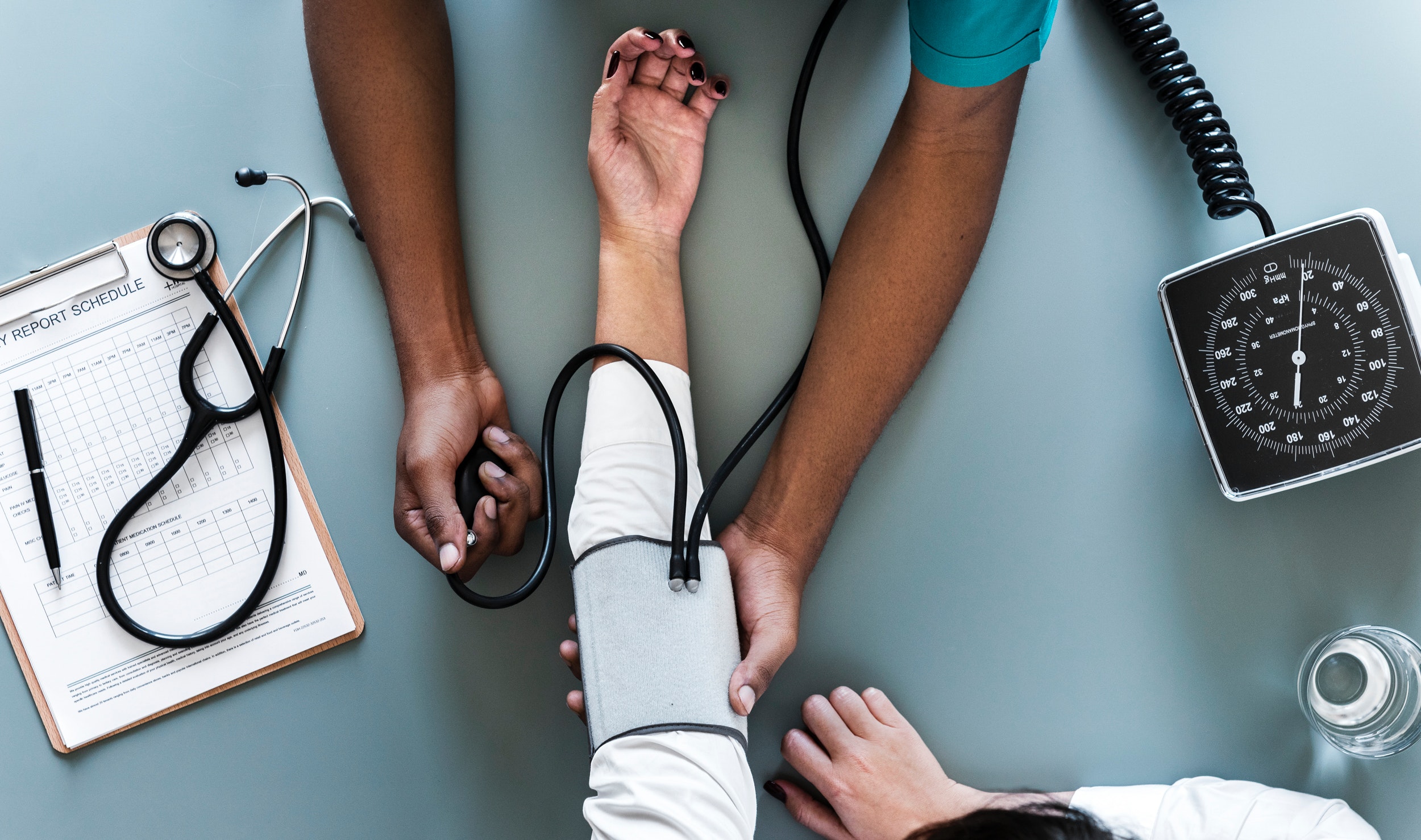 A physician checking a patient's blood pressure.