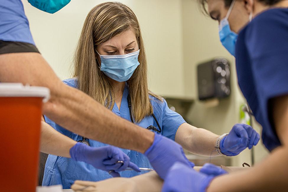 Polaris Dawn’s medical officer Anna Menon practices suturing an arm.