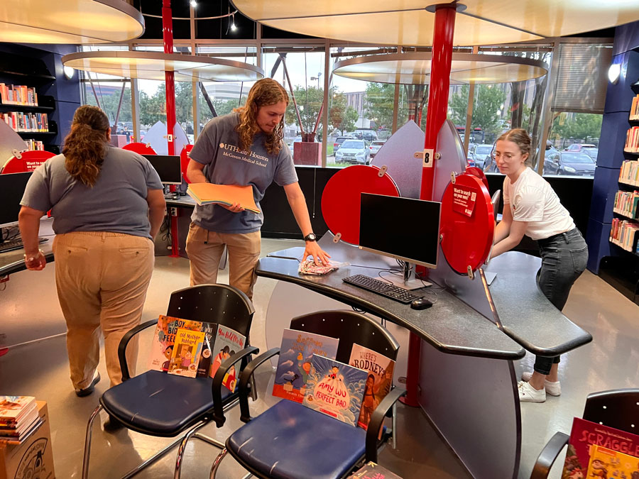 student volunteers helping set up kids play place to help look after family's children during the health fair