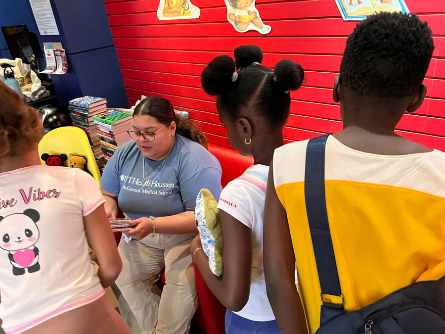 student volunteer looking after kids during the health fair