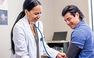 Nurse taking blood pressure of a patient