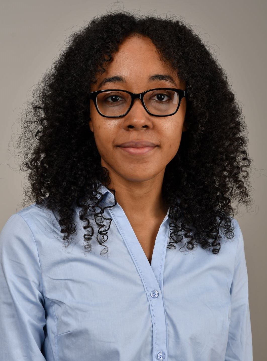 A long curl hair woman in light blue shirt