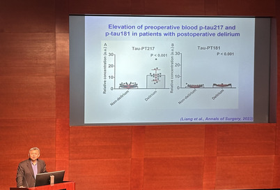 Zhoncong Xie standing at the podium during a seminar talk