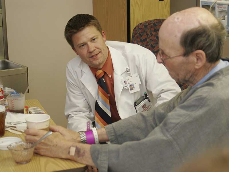 Social Connections A Doctor talking with an elderly patient