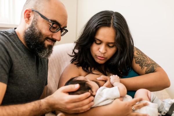 women breastfeeding with man to side