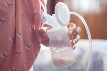 hand holding breast pump