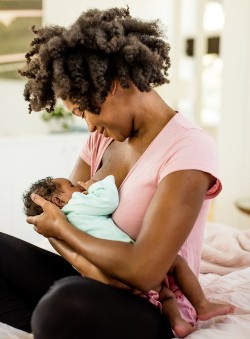 Black woman breastfeeding at lactation training facility