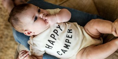 baby in shirt with text happy camper