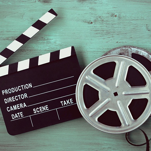 Humanities in Film logo, film reel and clapper board