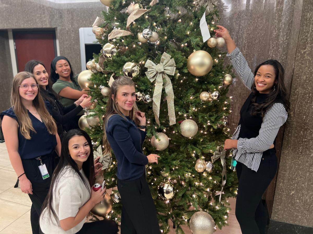 UT MSA Students Decorating the christmas tree in the lobby of UT Professional Building