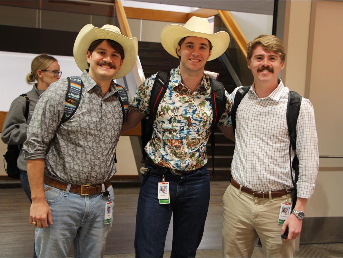 Photo of students Jake Chaconas, Robert Barton and Christopher Williams in their rodeo theme attire.