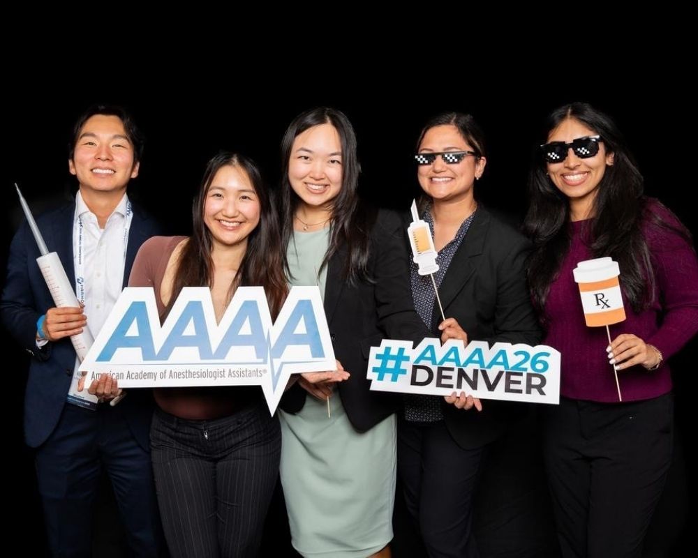 Second-year MSA students posing together in a photo booth at the AAAA Annual Conference.