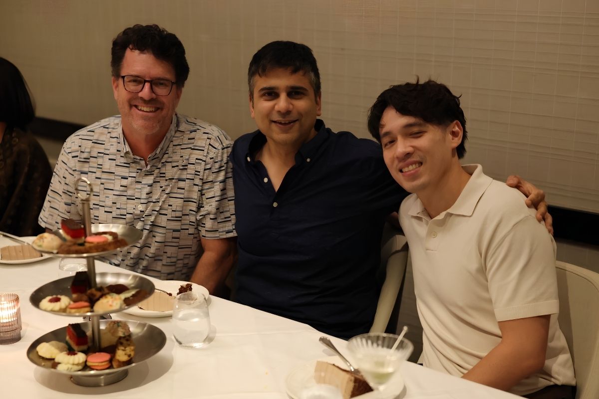 shane cunha, phd, rishi kumar, md, and charlie phung, caa poses for a photo at dinner table