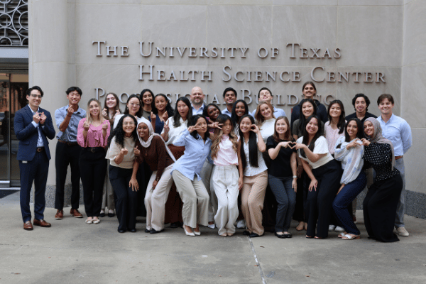 charlie phung, the msa program director, gives a wacky pose with the rest of the class of 2028 outside the utpb.