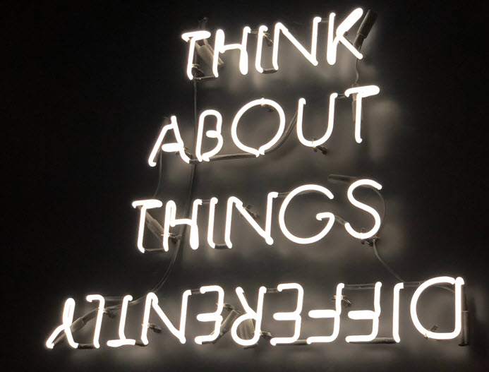 Neon Sign that says "Think about things differently. Differently is upside down