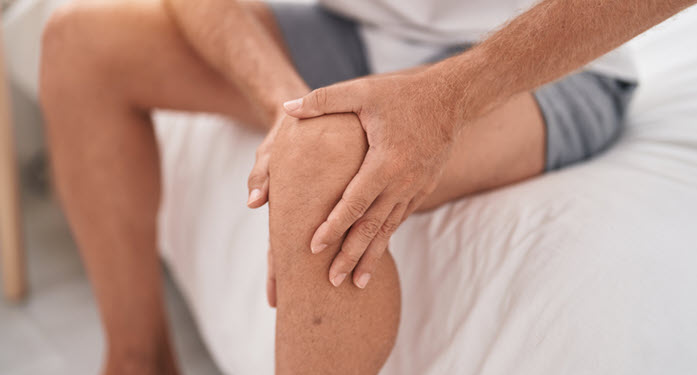 hands around knee (pain)