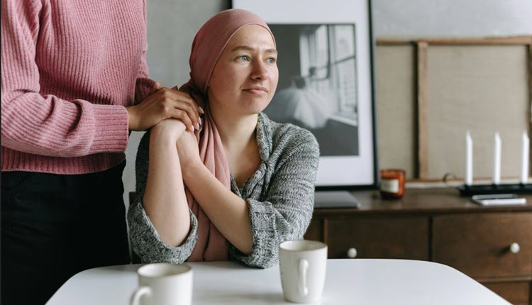 Female cancer patient with rose colored scarf