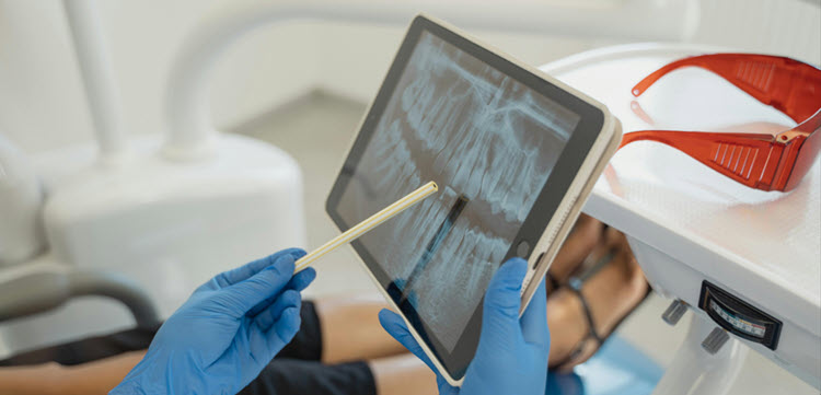 Oral Surgeon reading dental xray