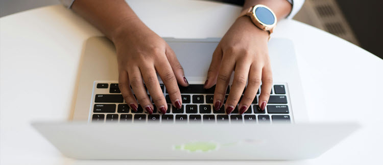 woman typing on laptop