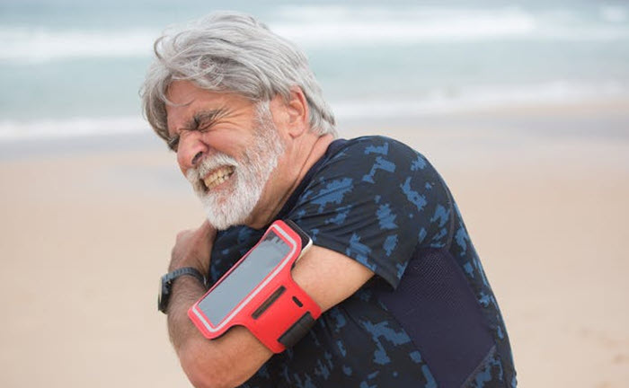 Shoulder injury - man grimacing