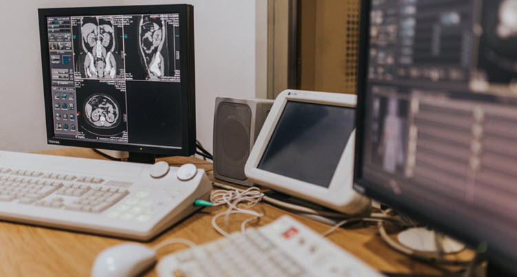 computers and monitors mouse and papers in an office