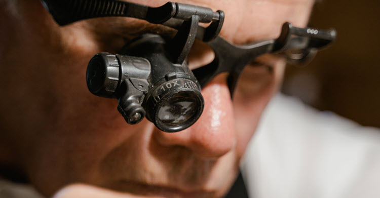 Man looking through monocles