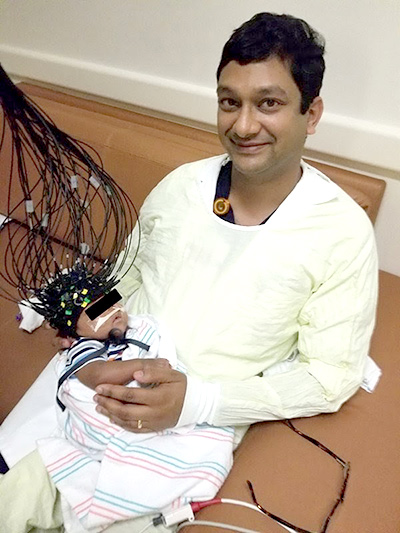 Dr. Manish Shah holding baby with CTOT