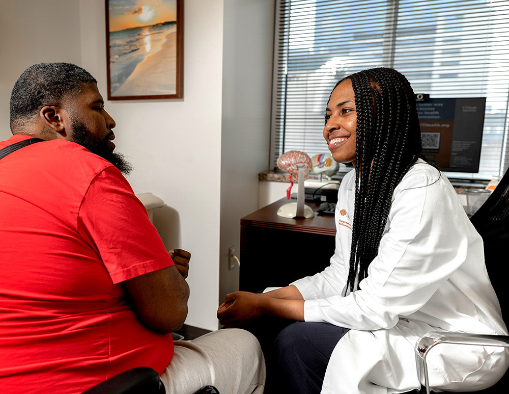 Neurologist Dr. Izeogu with patient