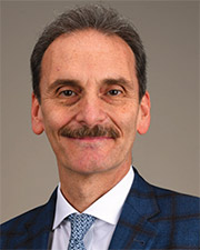 Dr Jacques Morcos blue suit