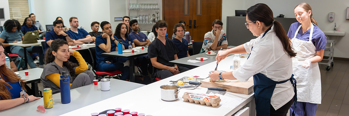 instructor and students at the Teaching Kitchen