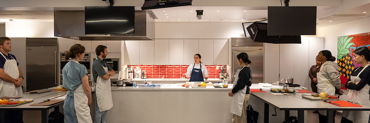 instructor and students at the Teaching Kitchen