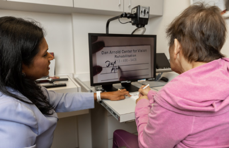 Dr Iyer, Low Vision specialist with patient