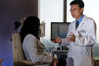 Tang Ho, MD, with Patients