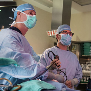 two doctors perform surgery