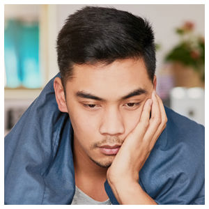 man leaning his face on his hand