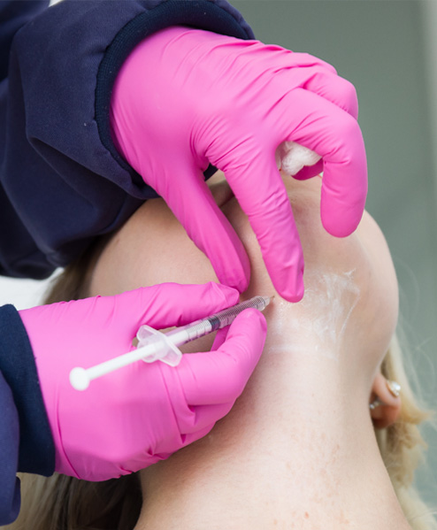Houston specialist administering Kybella injection under the chin – Texas Center for Facial Plastic Surgery