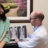 Dr. Borden holding xray of scoliosis