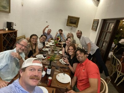 Front row, from left: William McGarvey, M.D.; William Harvin, M.D.; David Quintana-Rodriguez, M.D., and other volunteers having dinner after a long day in the OR (Photo provided by Dr. Harvin)