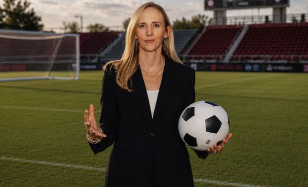 Bonnie Gregory, MD, orthopedic sports medicine surgeon at UTHealth Houston and team physician for the Houston Dash, stands on a soccer field holding a soccer ball.