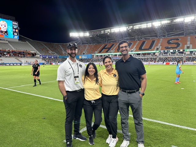 Jessica Traver, MD, and colleagues from the Houston Dash on the sidelines after game coverage