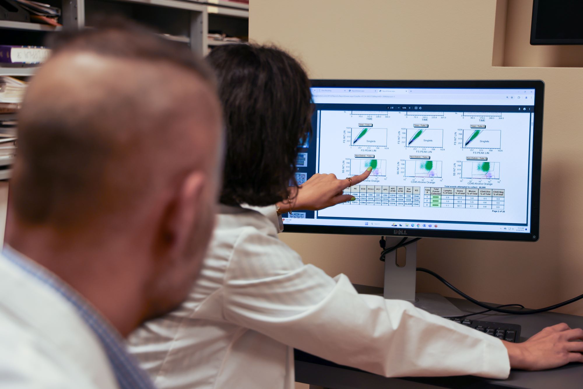 Attending and resident looking at flow cytometry