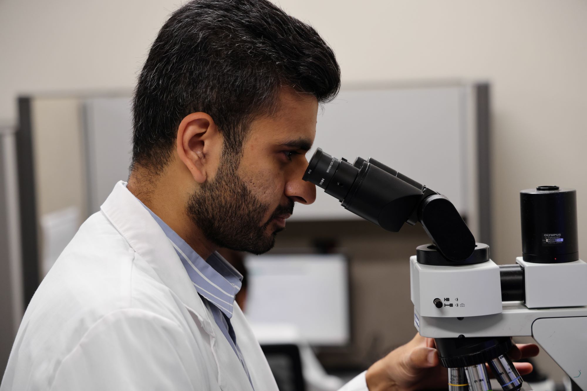 Resident looking in microscope