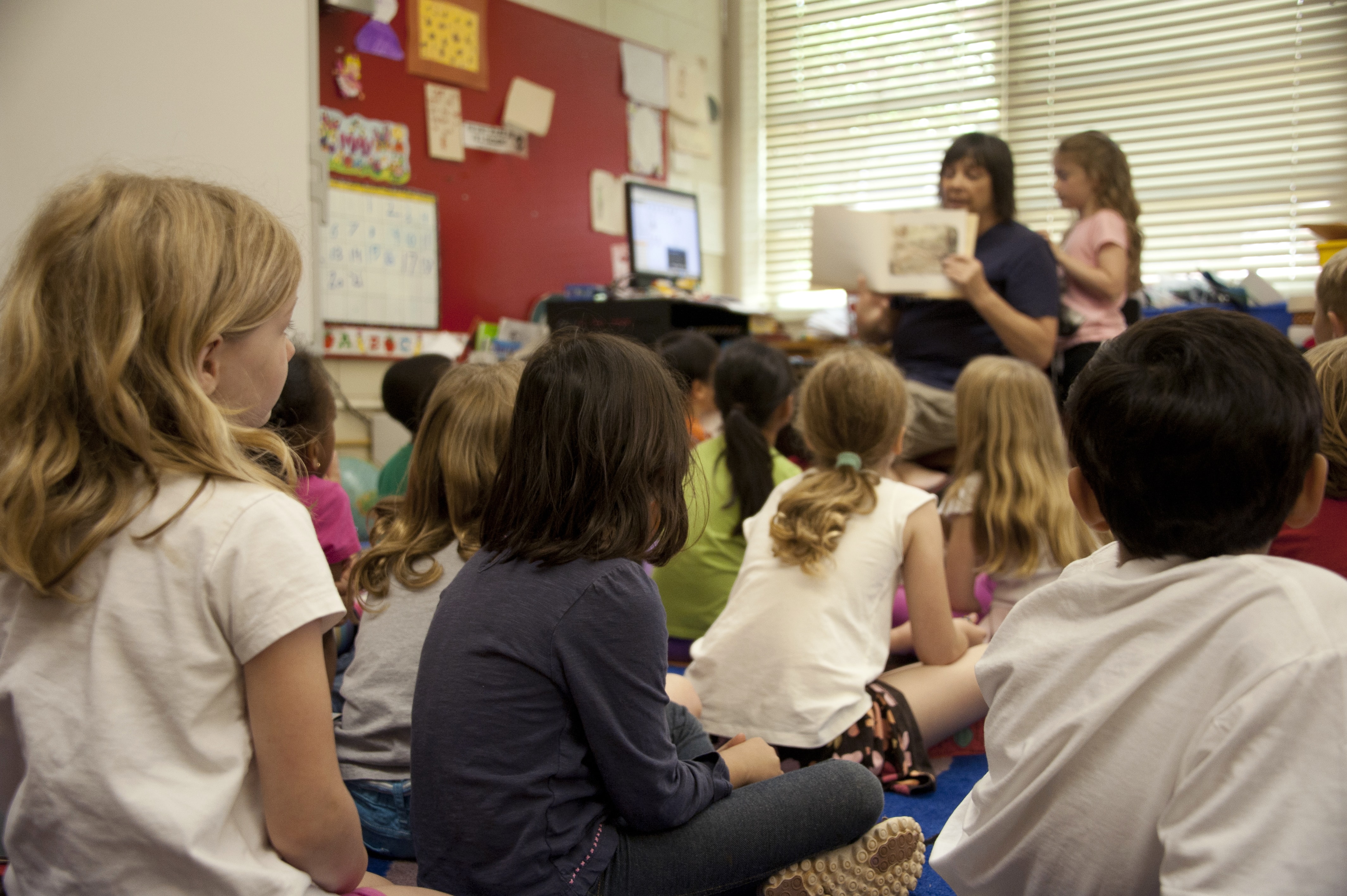 Teacher reading a story to children