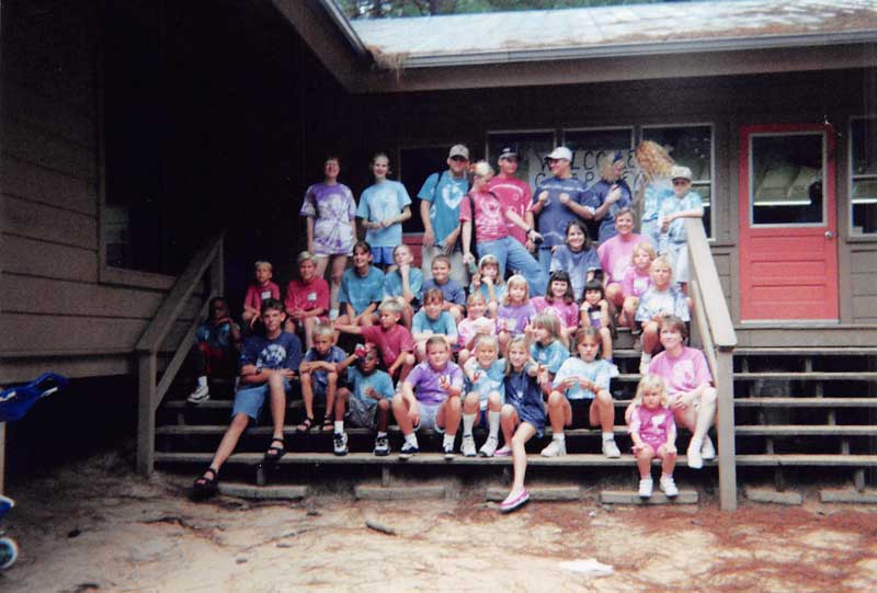 group photograph in front of cabin