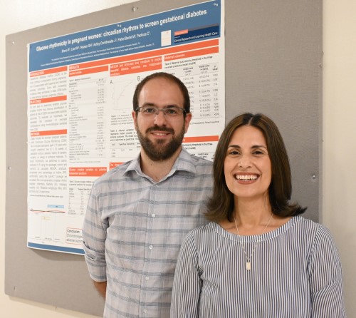 Dr. Bravo-Santos and his mentor, Dr. Pedroza, standing in front of their research poster.